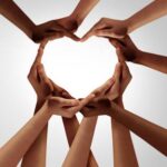 hands coming together in the shape of a heart